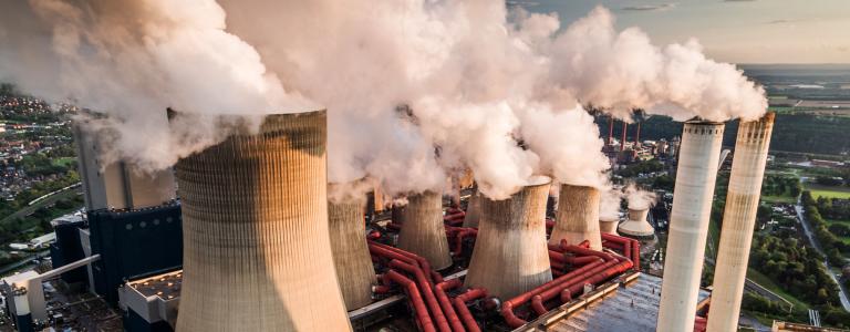 A coal plant emits fumes.